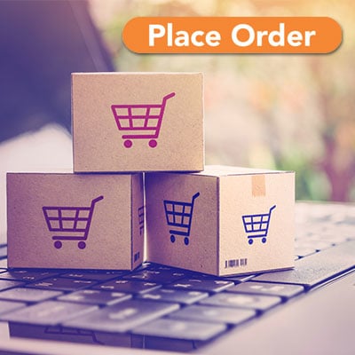 Boxes with digital shopping cart printed on them sitting on laptop keyboard with text Place Order in orange button.